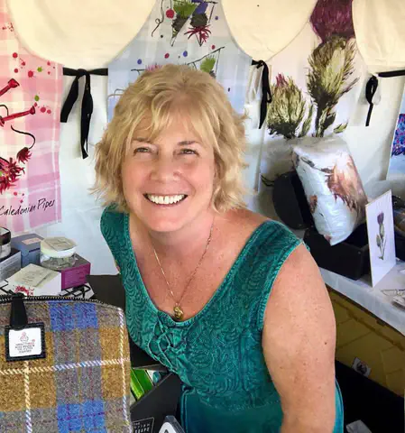 Scottish Creations vendor with tartan accessories and Scottish-themed gifts on display.
